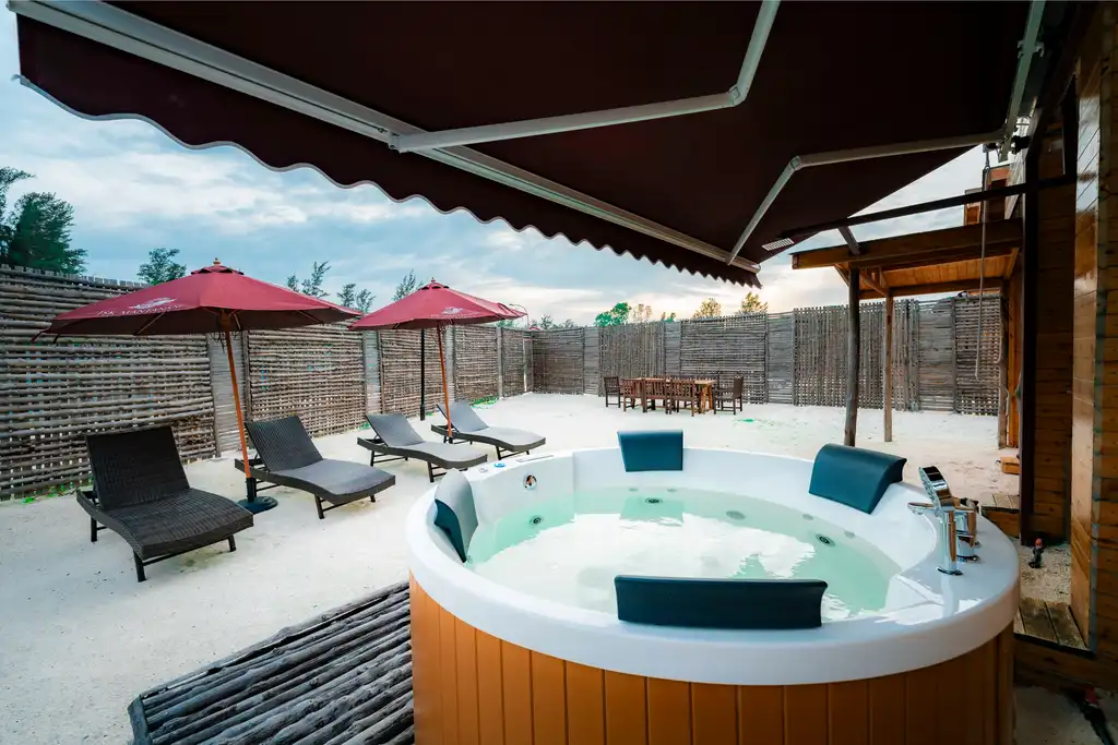 Private outdoor jacuzzi overlooking the turquoise waters and scenic views from the double-storey bungalow at JSK Mantanani Island Resorts.